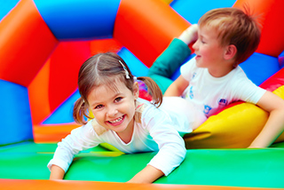 Kids in Bouncy Castle - Planning Safe Festivals -  Church Mutual